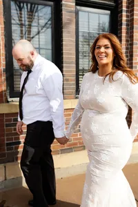 Bride and groom walking together on their wedding day after makeup by Alexa Navis, Minneapolis wedding makeup artist