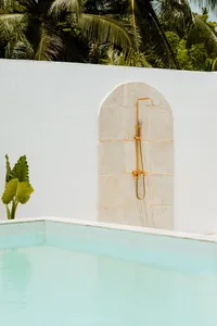 processed_Somewhere Inbetween - Minimalist outdoor shower with turquoise pool and tropical p - TVS