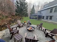 Backyard fire pit and seating area at Brookside Retreat
