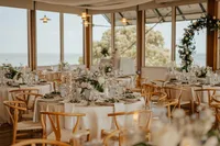 The indoor Canvasback Dining Room at Chesapeake Bay Foundation Weddings and Events with floor-to-ceiling windows and views of the Bay
