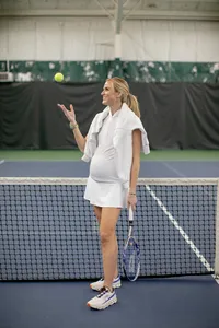 Pregnant woman's branding portrait on the tennis court