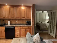 Wood cabinetry and beverage area in the Brookside Retreat den