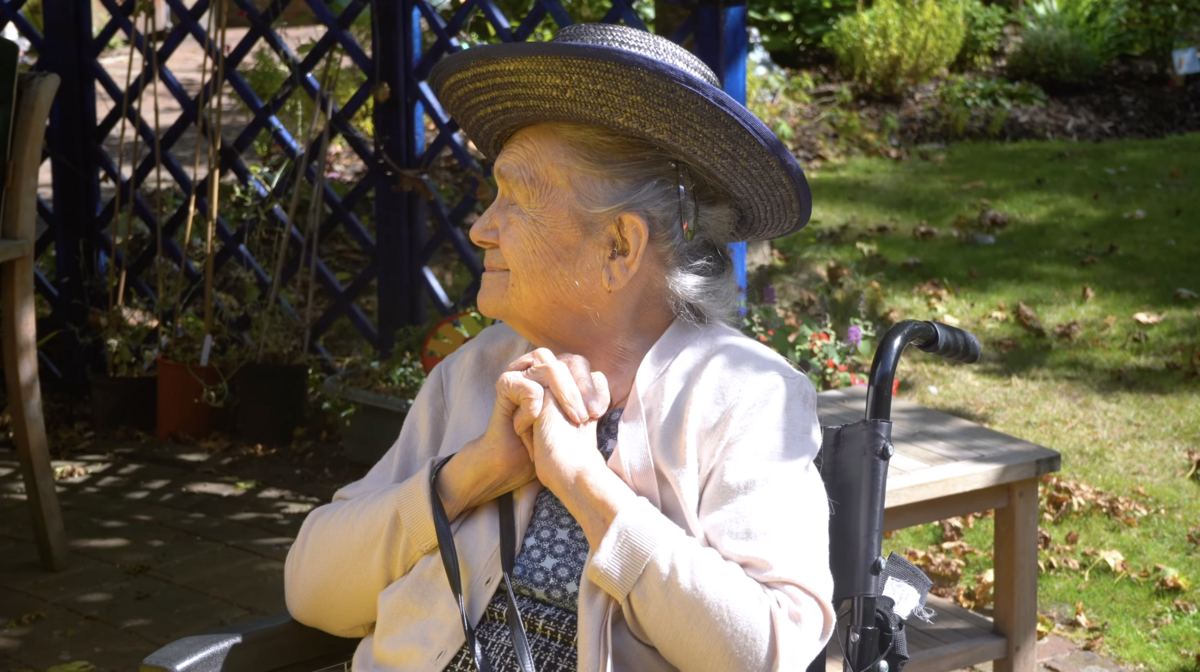 A resident enjoying the garden at a care home