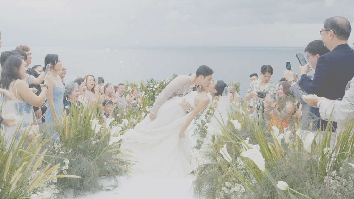 Bride posing on a cliffside garden terrace at Ayana Resort wedding in Bali