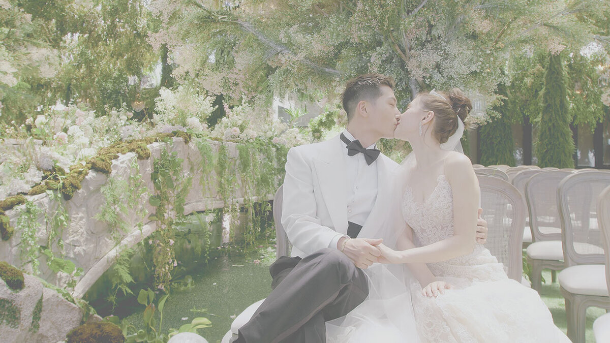 Bride and groom sharing a kiss during their clifftop wedding at Six Senses Uluwatu, Bali