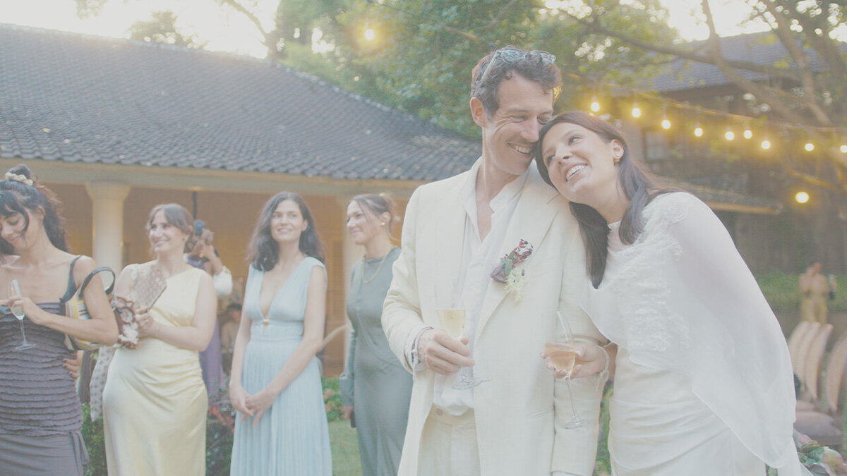 Bride and groom laughing together at their heritage hotel wedding reception in Bali