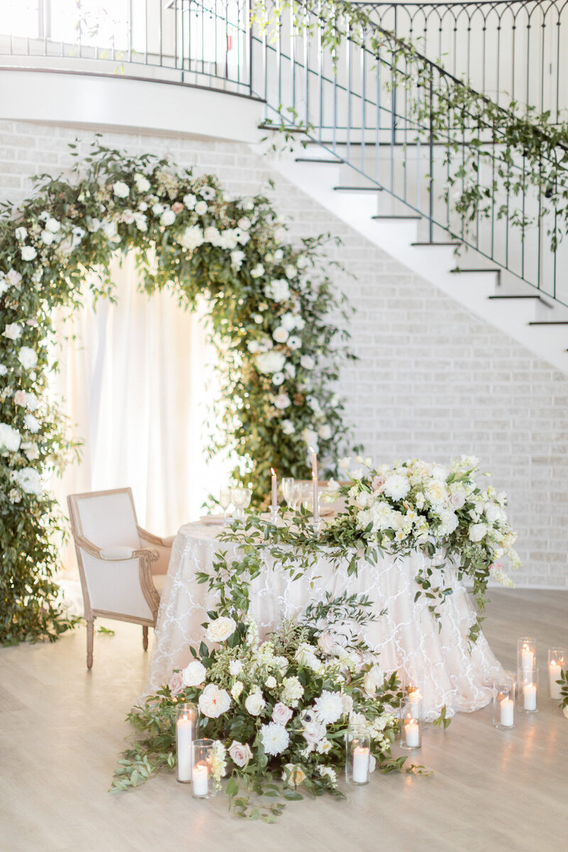 White and green wedding ceremony arch