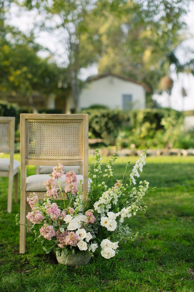Pink and white aisle floral arrangements