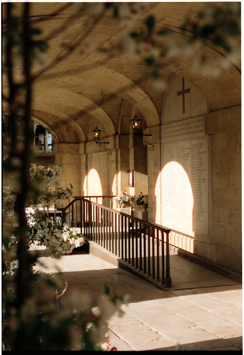 Sunlit stone cloister on the wedding day, shot on 35mm CineStill film