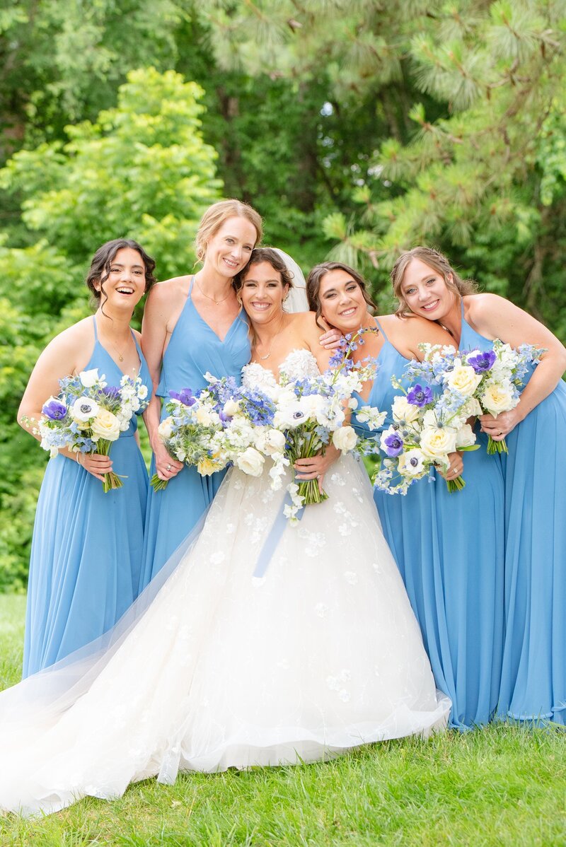 Bridesmaids with blue and white bouquets