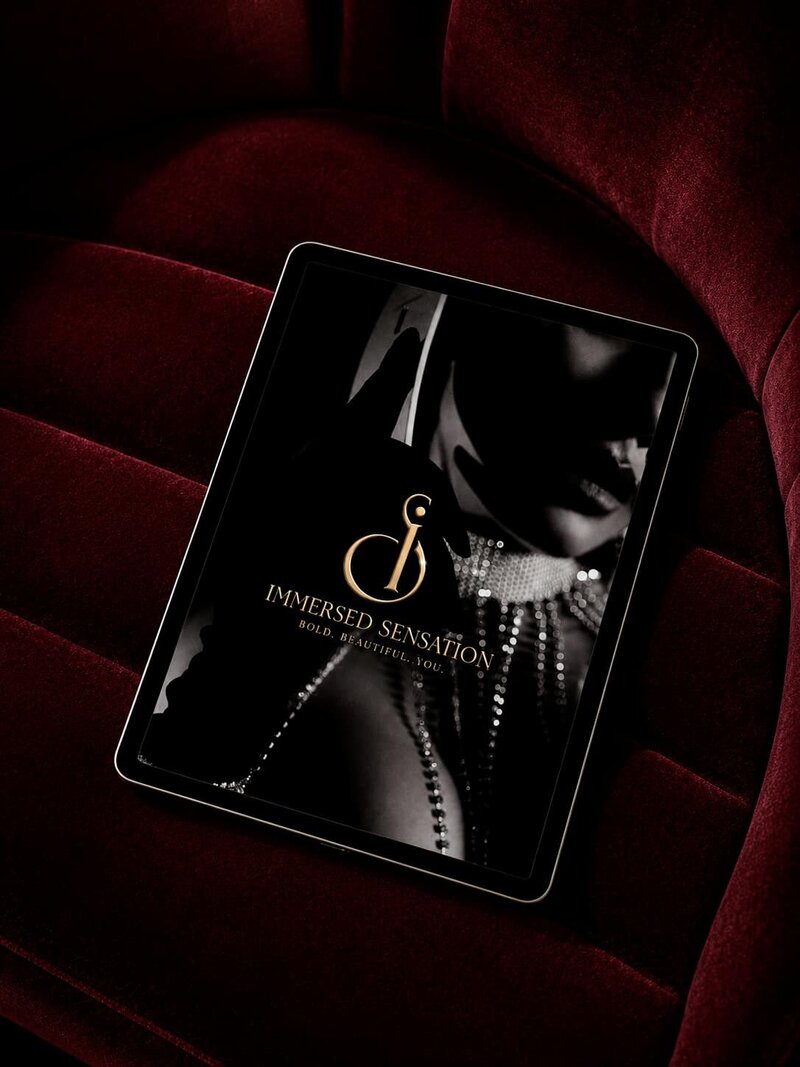 Immersed Sensation logo displayed on an iPad resting on dark red velvet