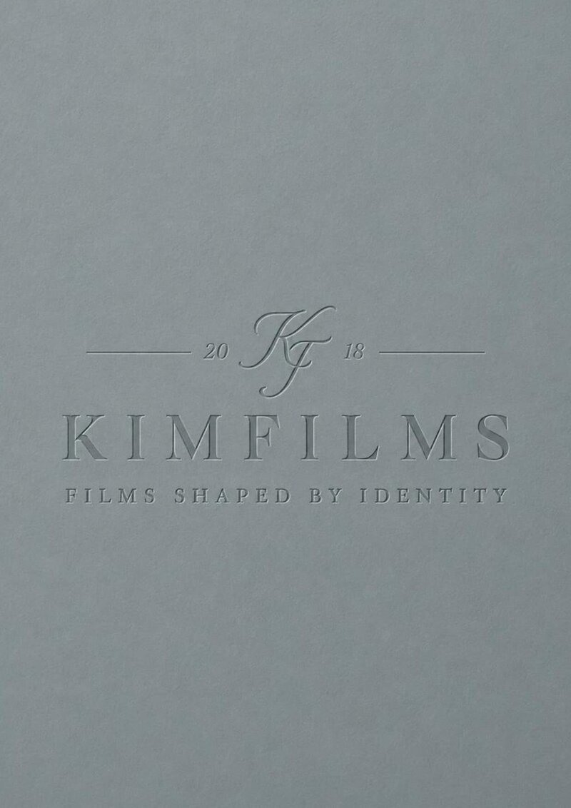 Embossed KimFilms logo on grey textured paper with the tagline Films Shaped by Identity