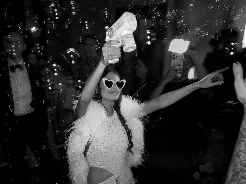 Guest celebrating on a wedding dance floor filled with bubbles