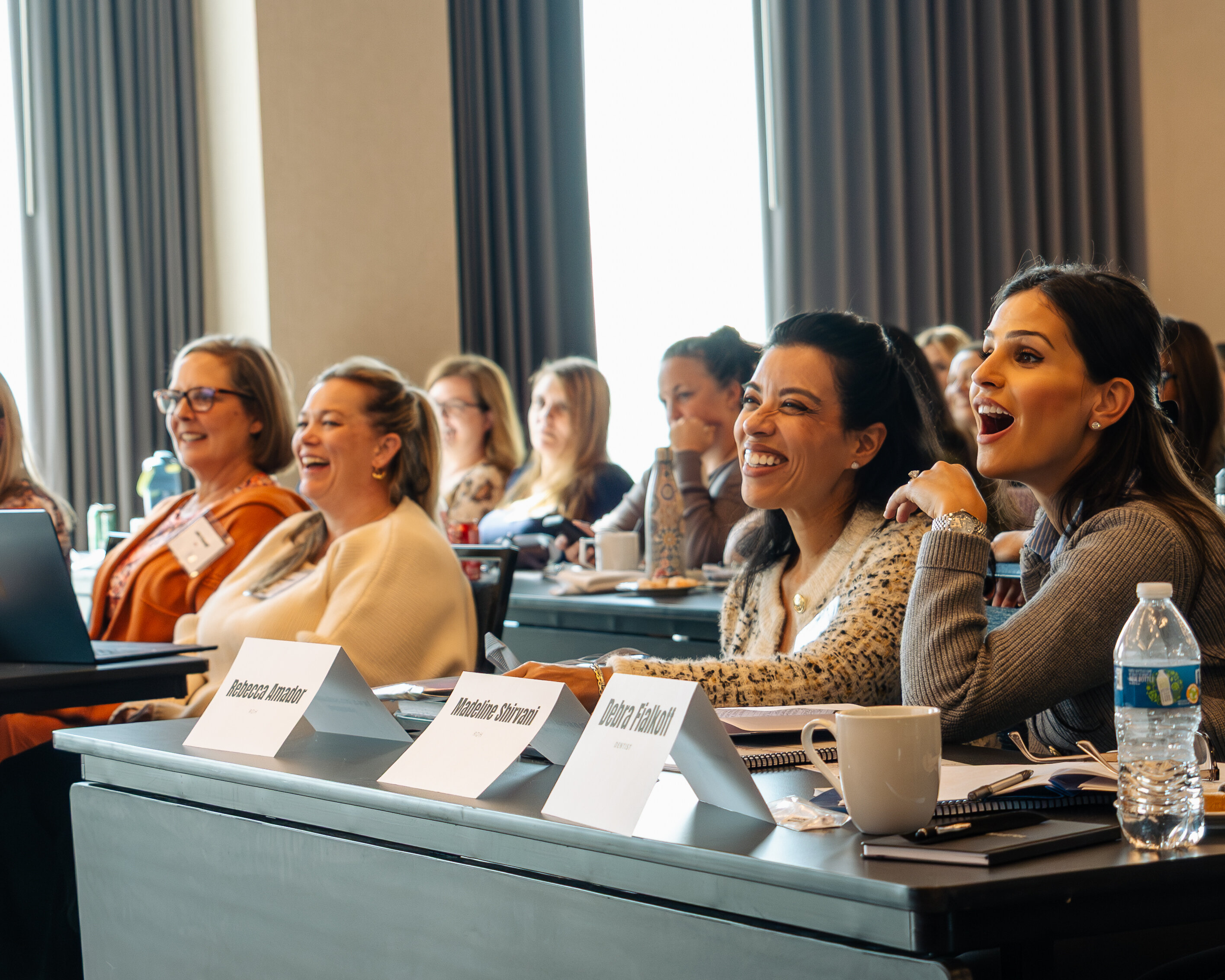 Dental team members sharing a laugh at the Perio Summit