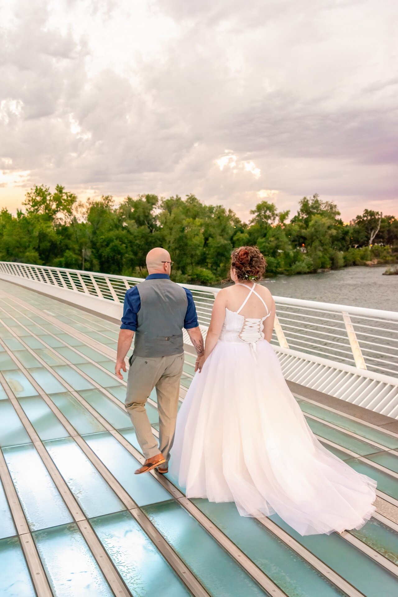 True-to-color California wedding portrait of a couple on a bridge in Redding