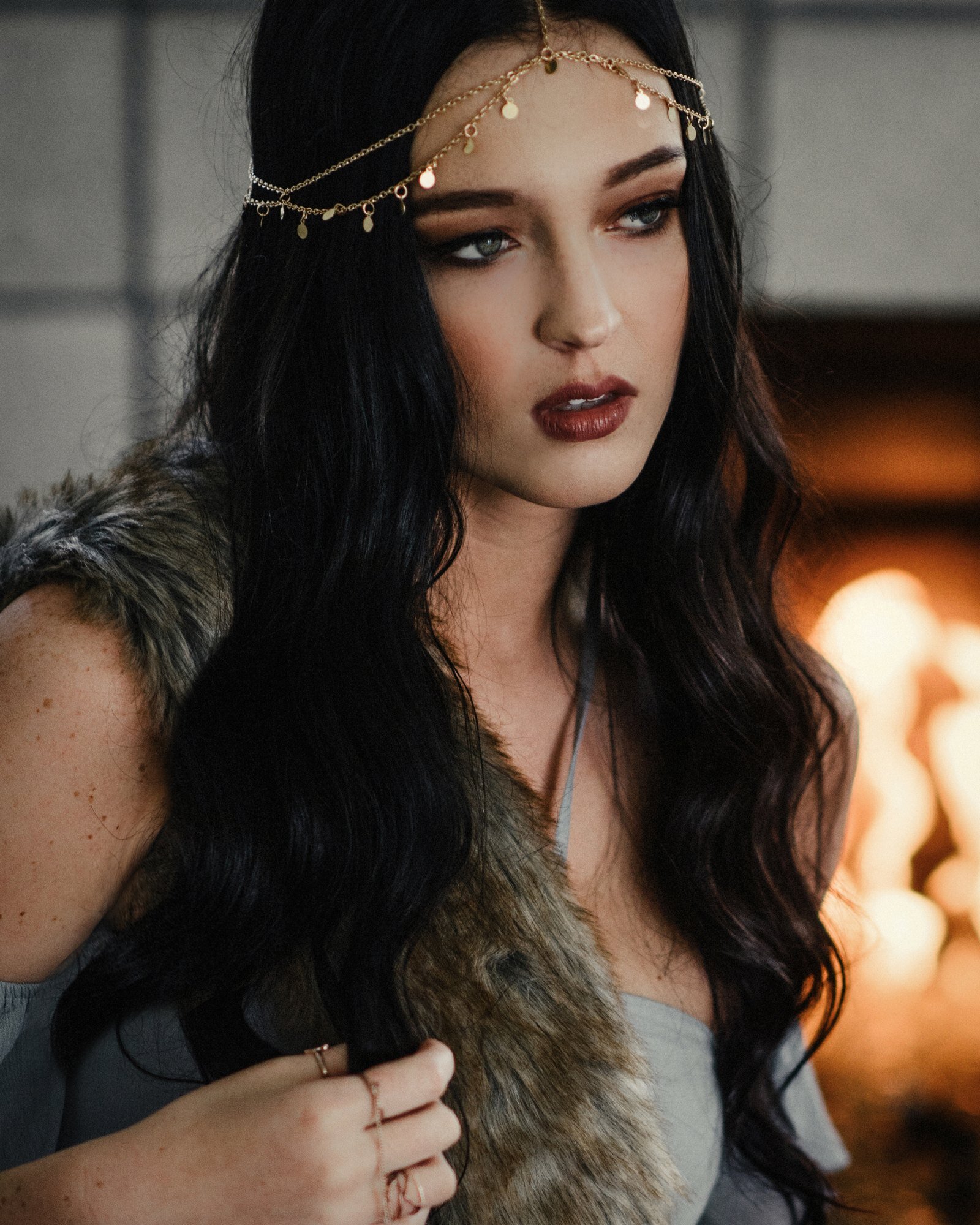 High school senior with long dark hair wearing a gold head chain, editorial senior portrait by Renee Bowen