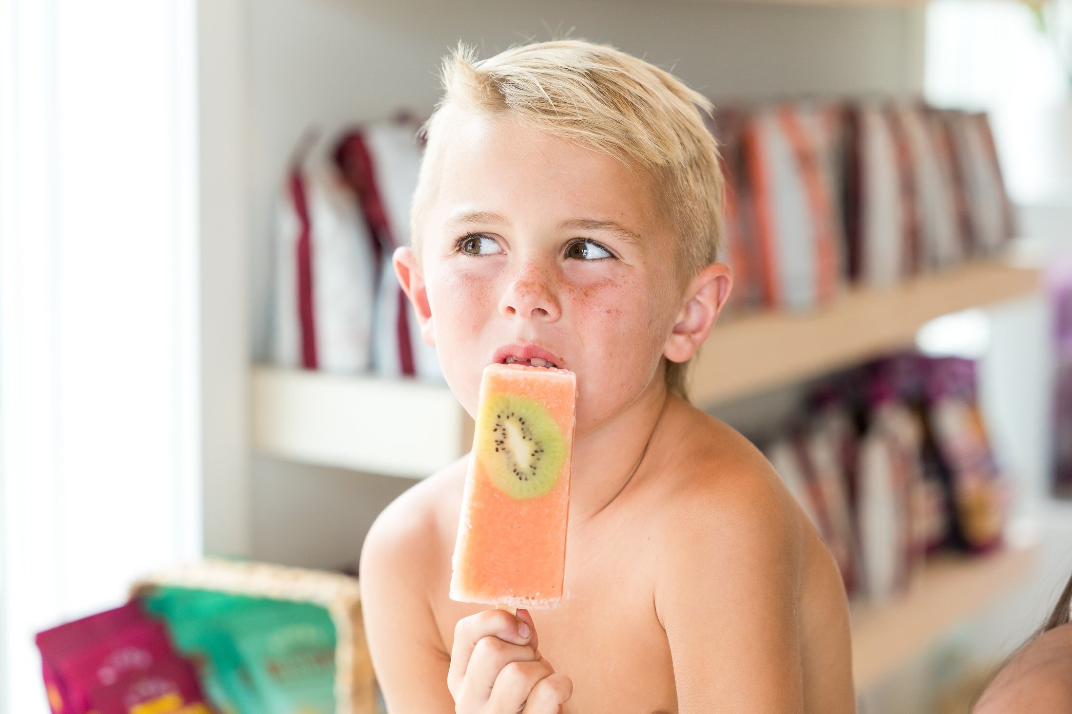 Child enjoying a popsicle treat at Real + Raw 30A