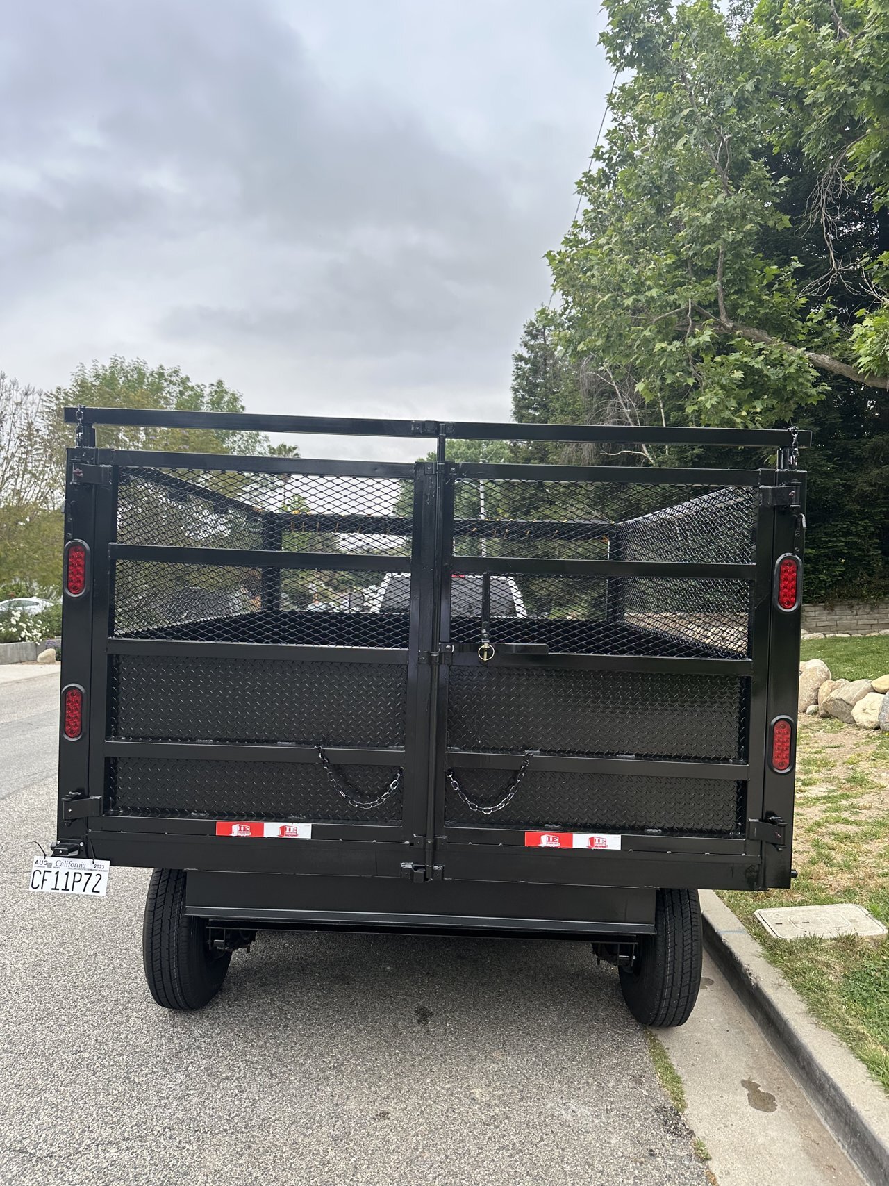 Rear loading doors on the compact black dumpster trailer