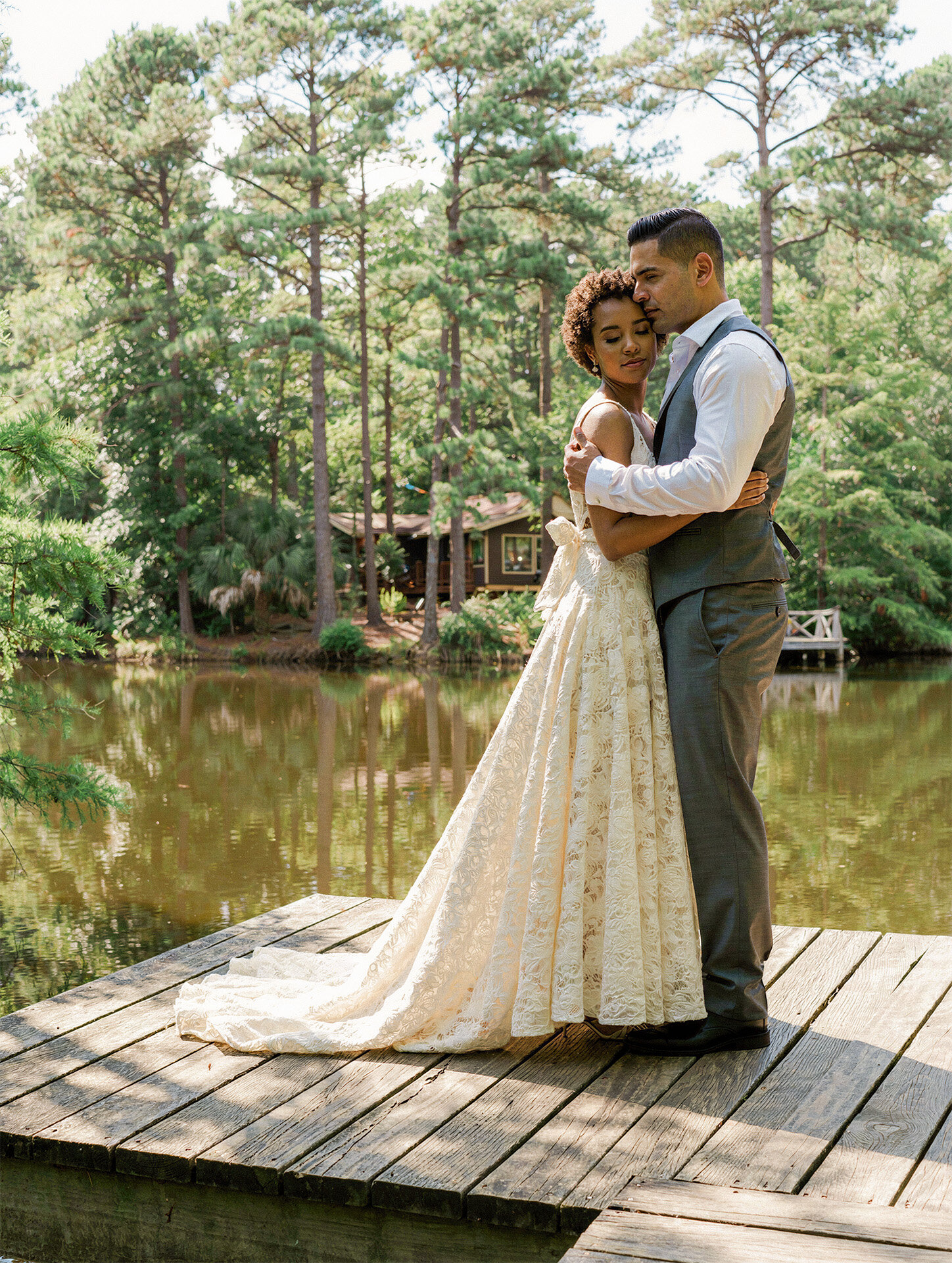Bride and groom embracing at a private lake house wedding in the East Texas Piney Woods