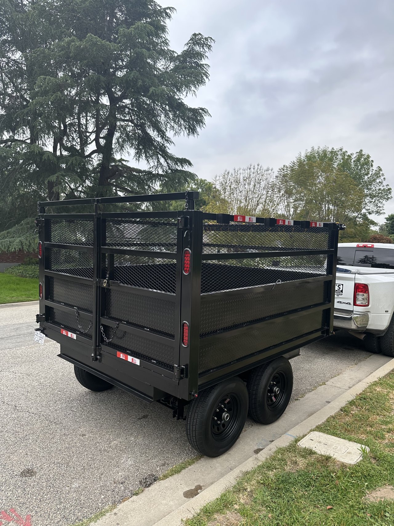 The Load Dumper trailer beside a residential driveway