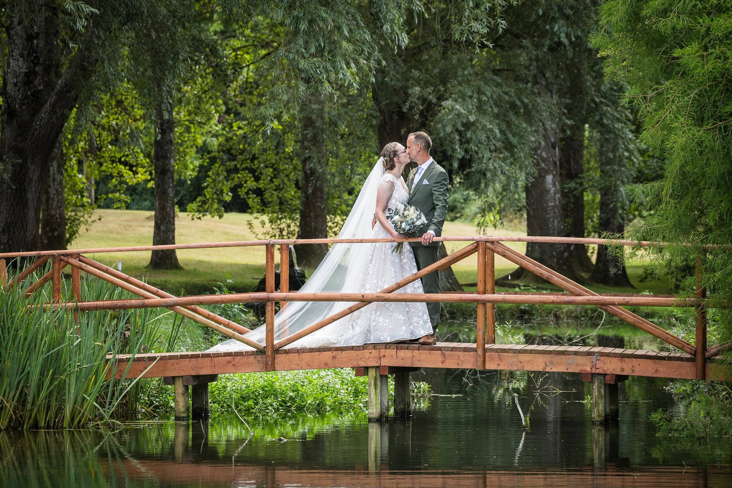 Bride and groom on wooden bridge
