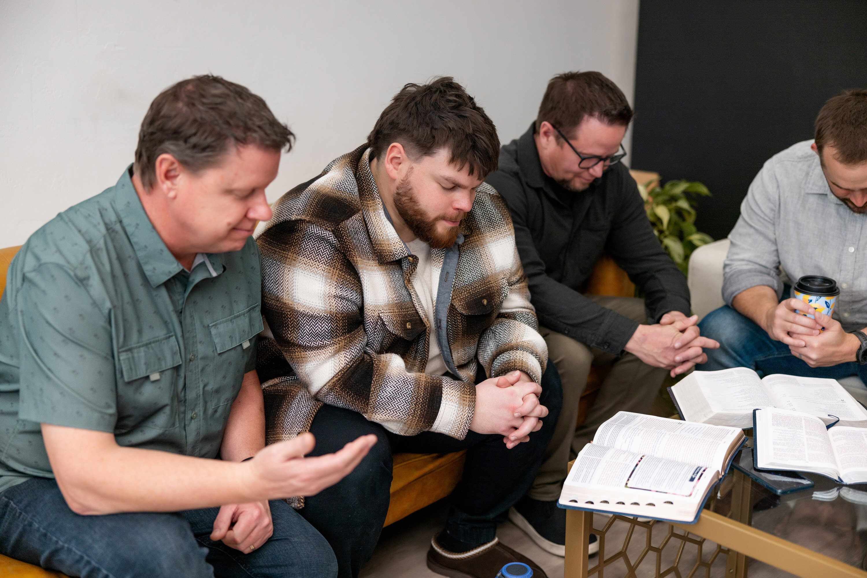 Church leaders review a ministry guide together at a table.