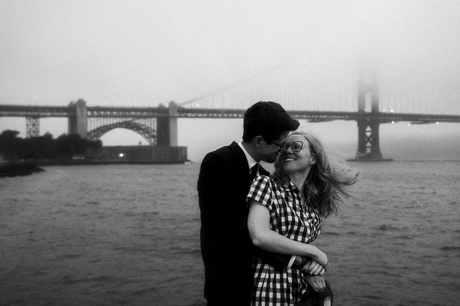 Melissa and Lee beside the Golden Gate Bridge in black and white