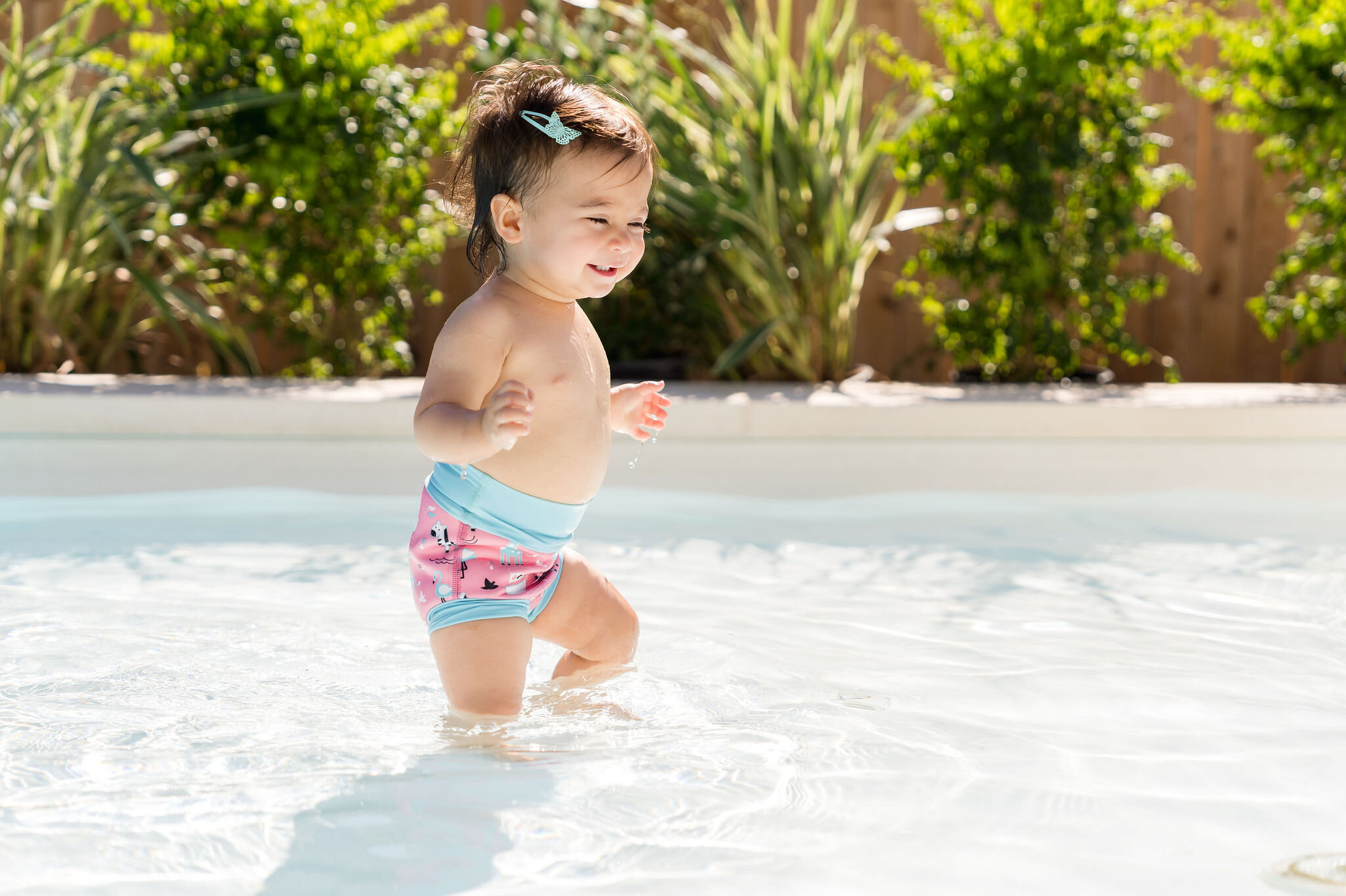 Underwater photography of a girl diving in a strawberry print swimsuit for Splash About
