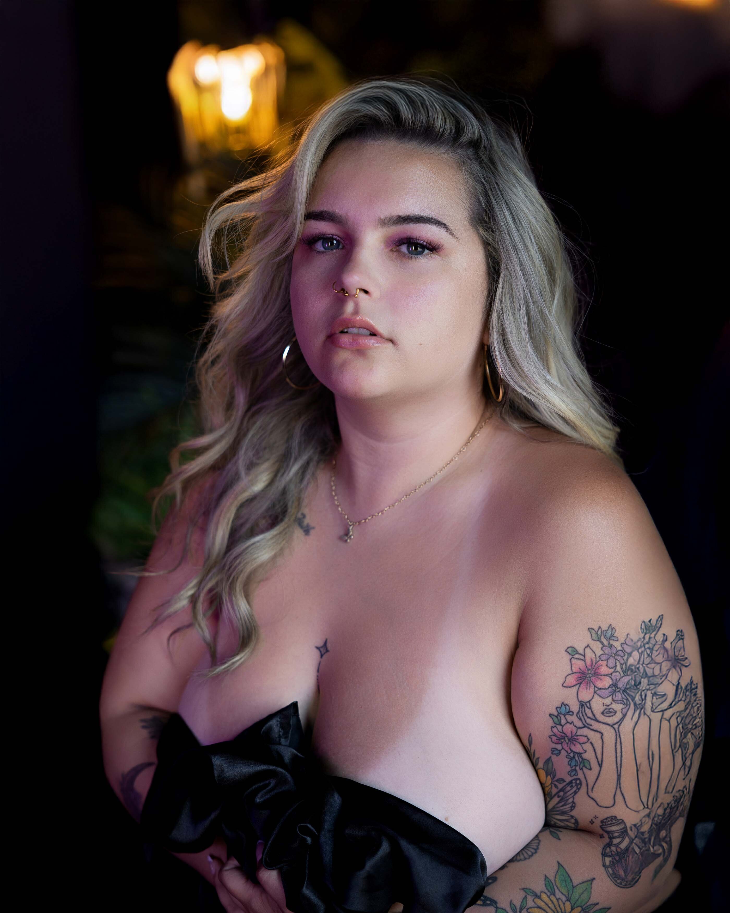 Woman posing with black sheet during her DC boudoir session