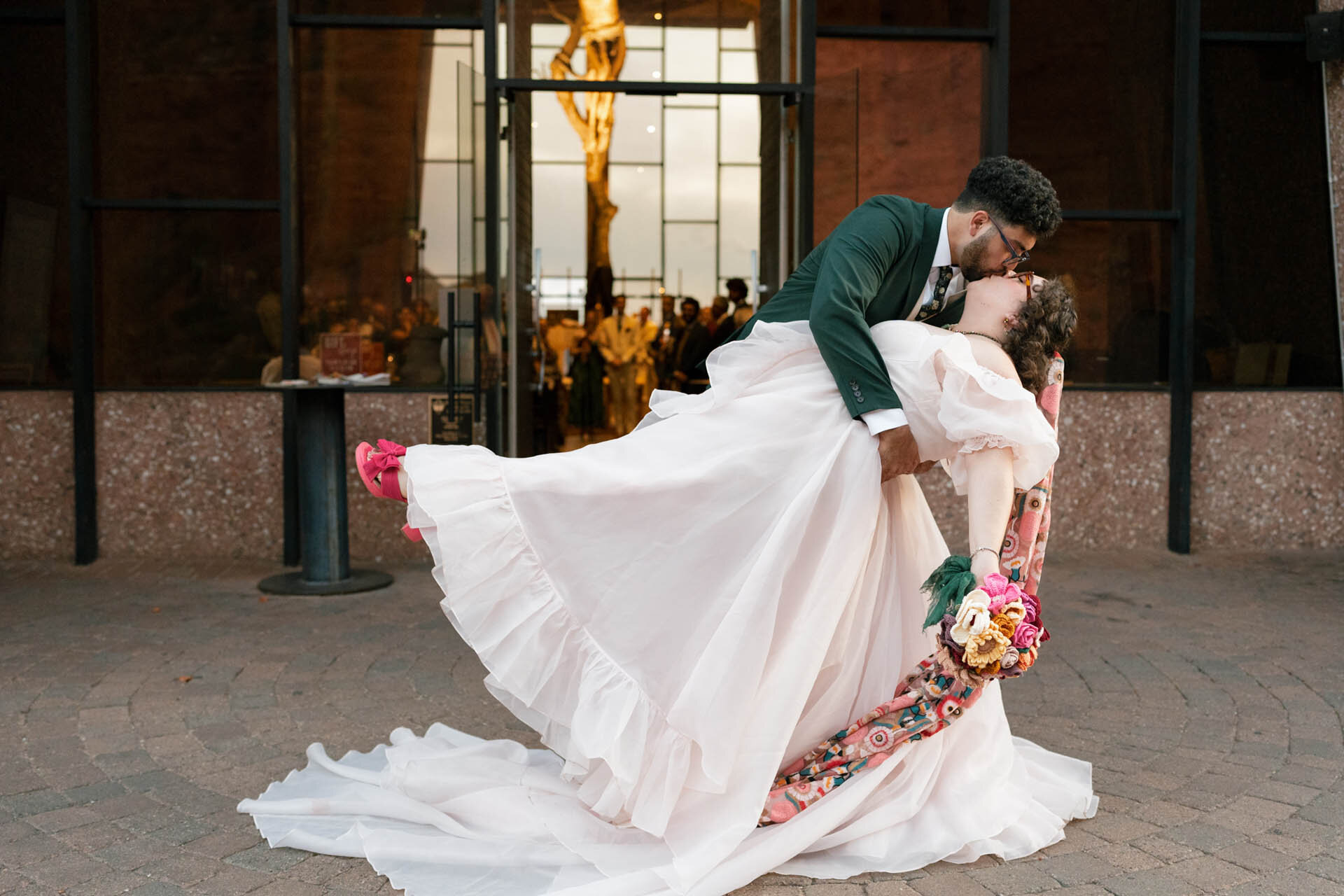 Couple in wedding attire near the Chapel of the Holy Cross in Sedona, Arizona