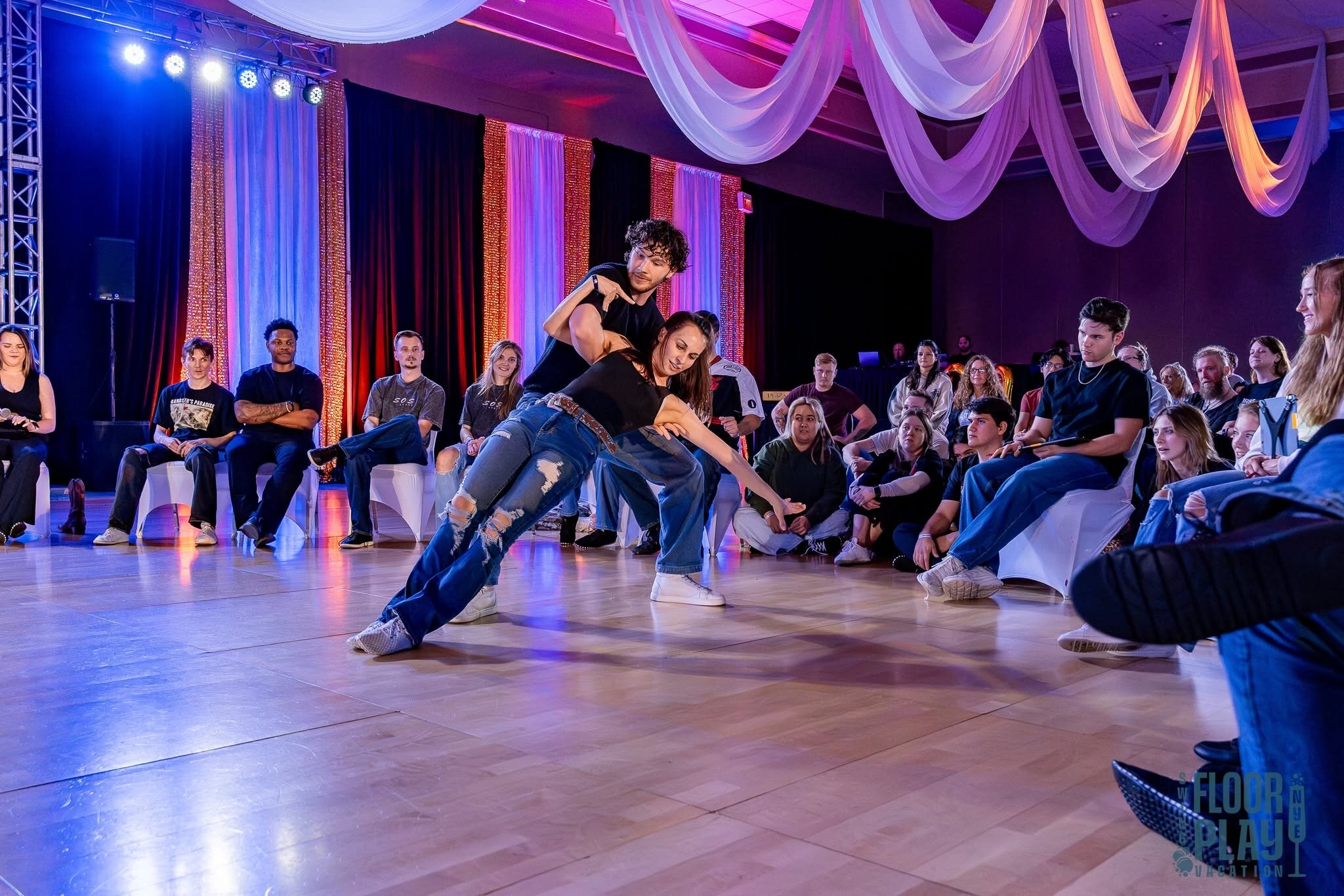 Country Swing partners competing in front of an audience at a past Floorplay event