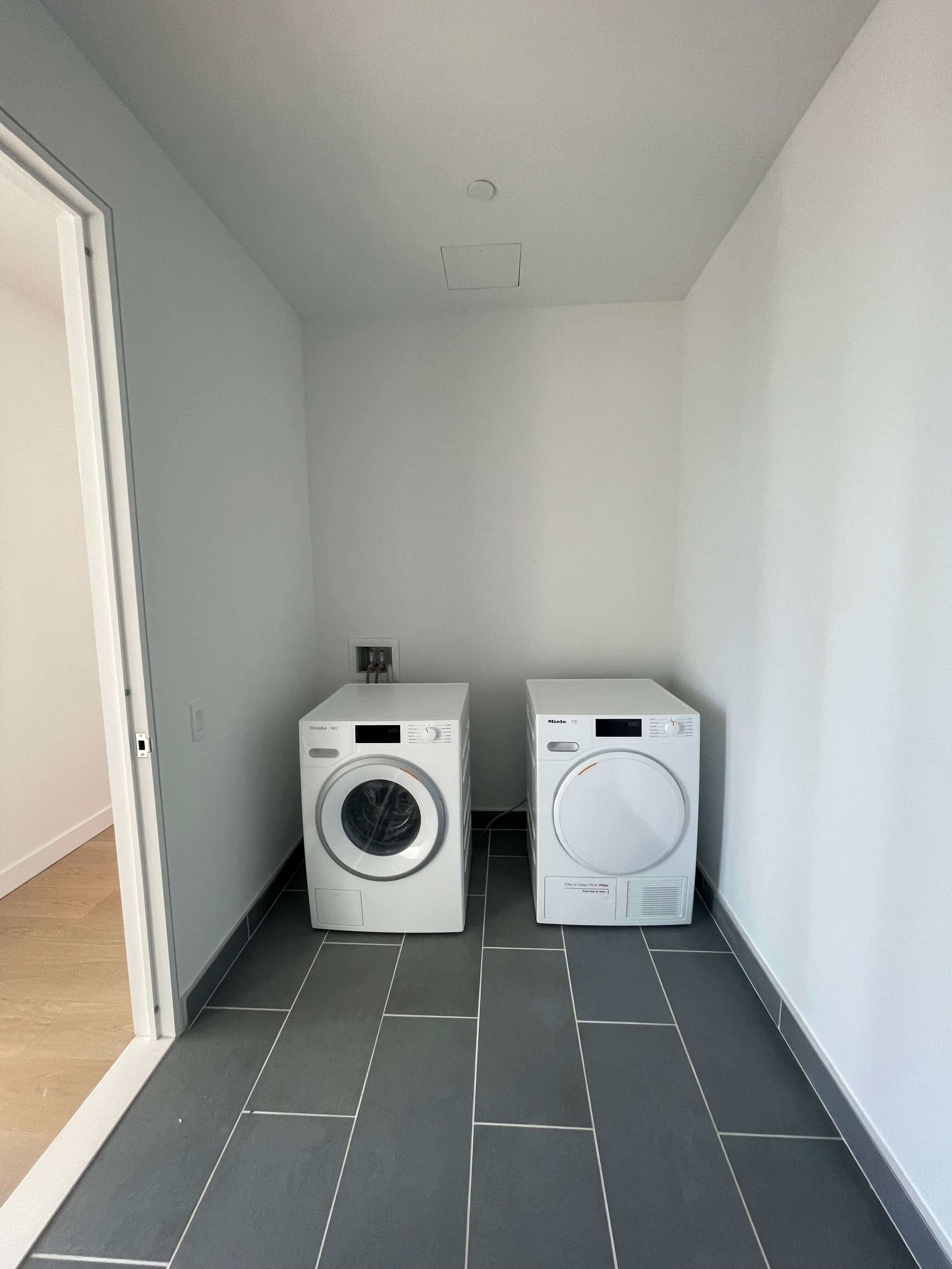 Laundry room storage area before professional home organization.