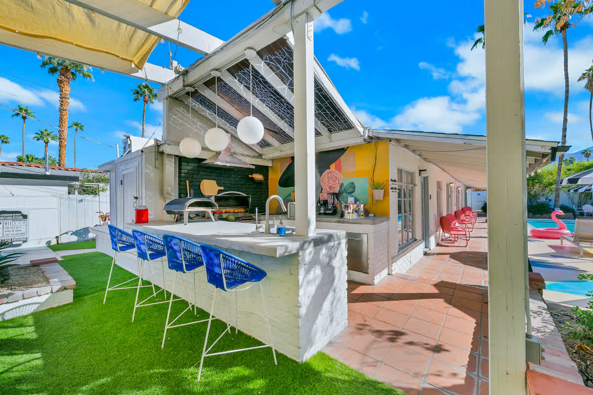 Outdoor kitchen with pizza oven and bar seating