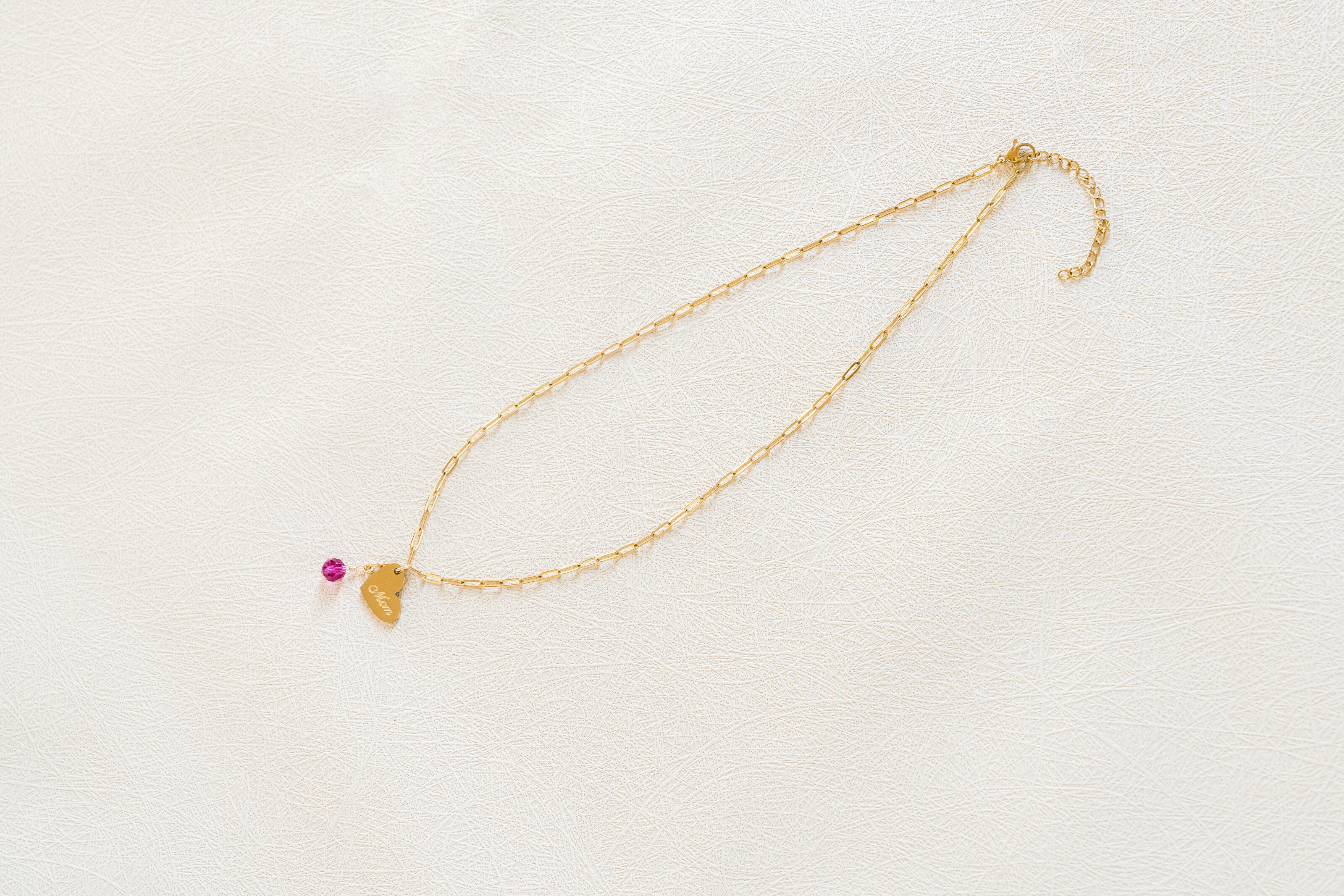 Flatlay of Charm Theory Mom heart charm necklace