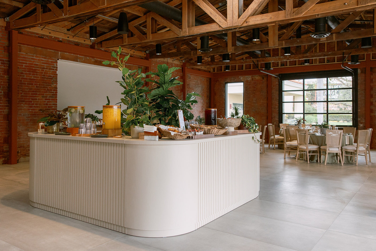 Palomino’s modular bar configured indoors with beverage dispensers, food displays and abundant greenery.