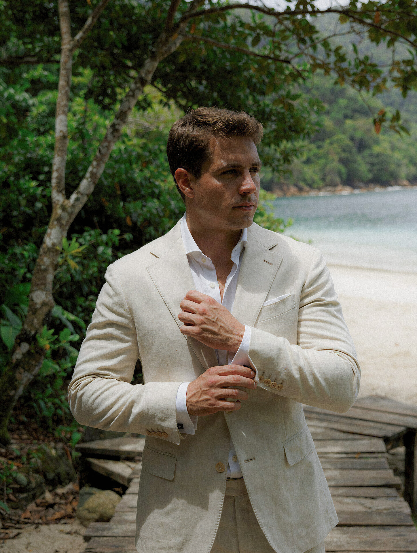 Groom portrait on a beach pier in Manuel Antonio, Costa Rica