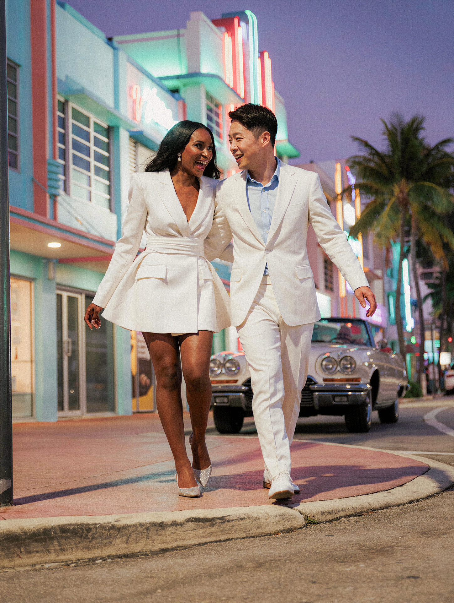 Bride and groom laughing on Ocean Drive in Miami Beach Florida wedding photography