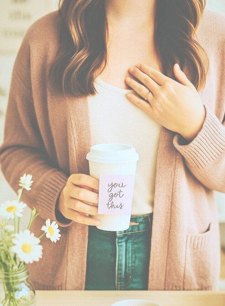 Woman holding coffee cup that says you got this
