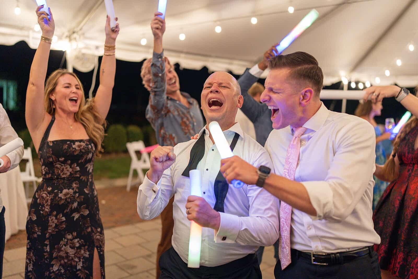 Guests dancing with glow sticks at a wedding reception in Richmond, Virginia at lewis ginter