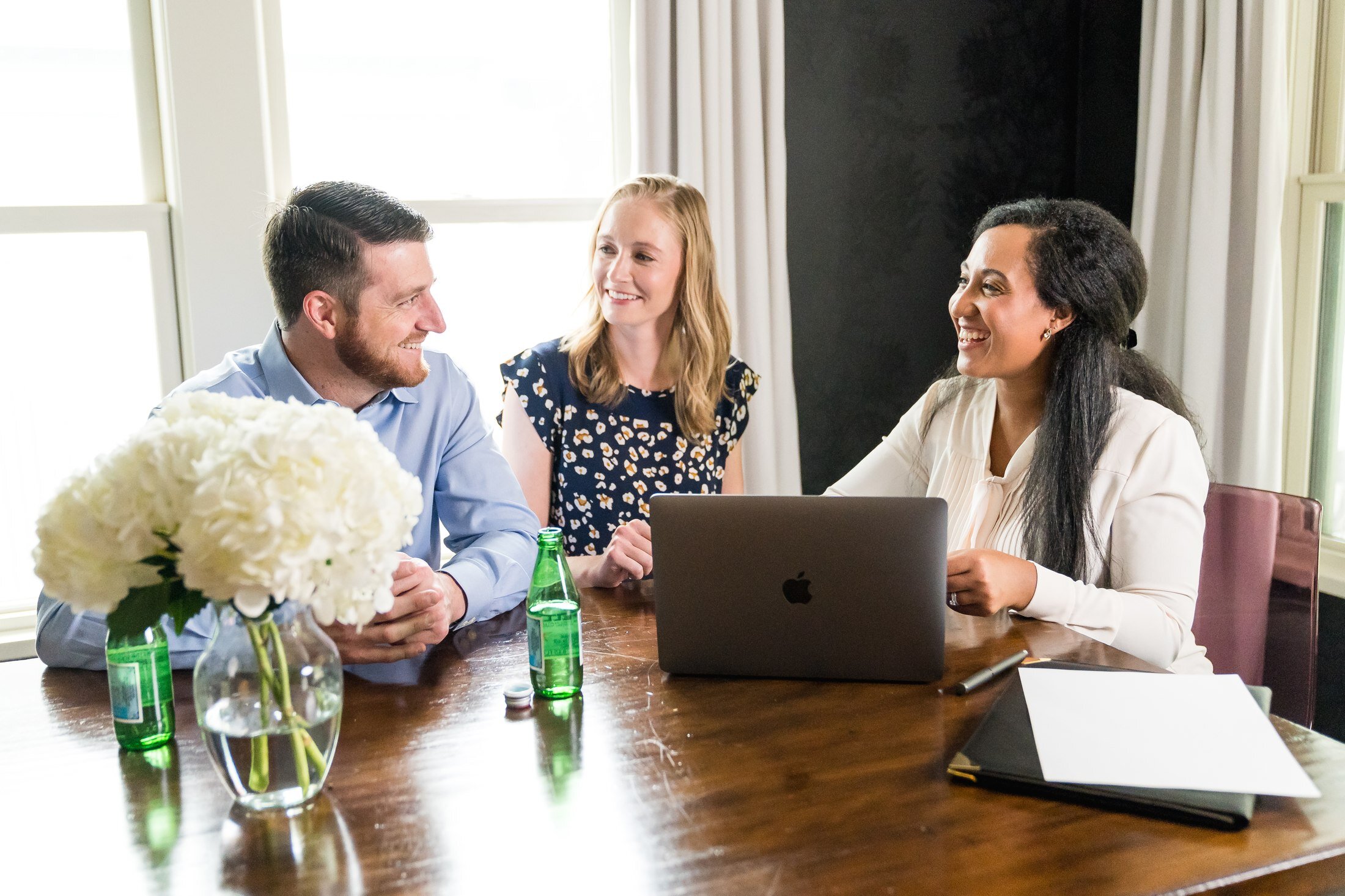 Vacasa team having a conversation over a laptop in Austin