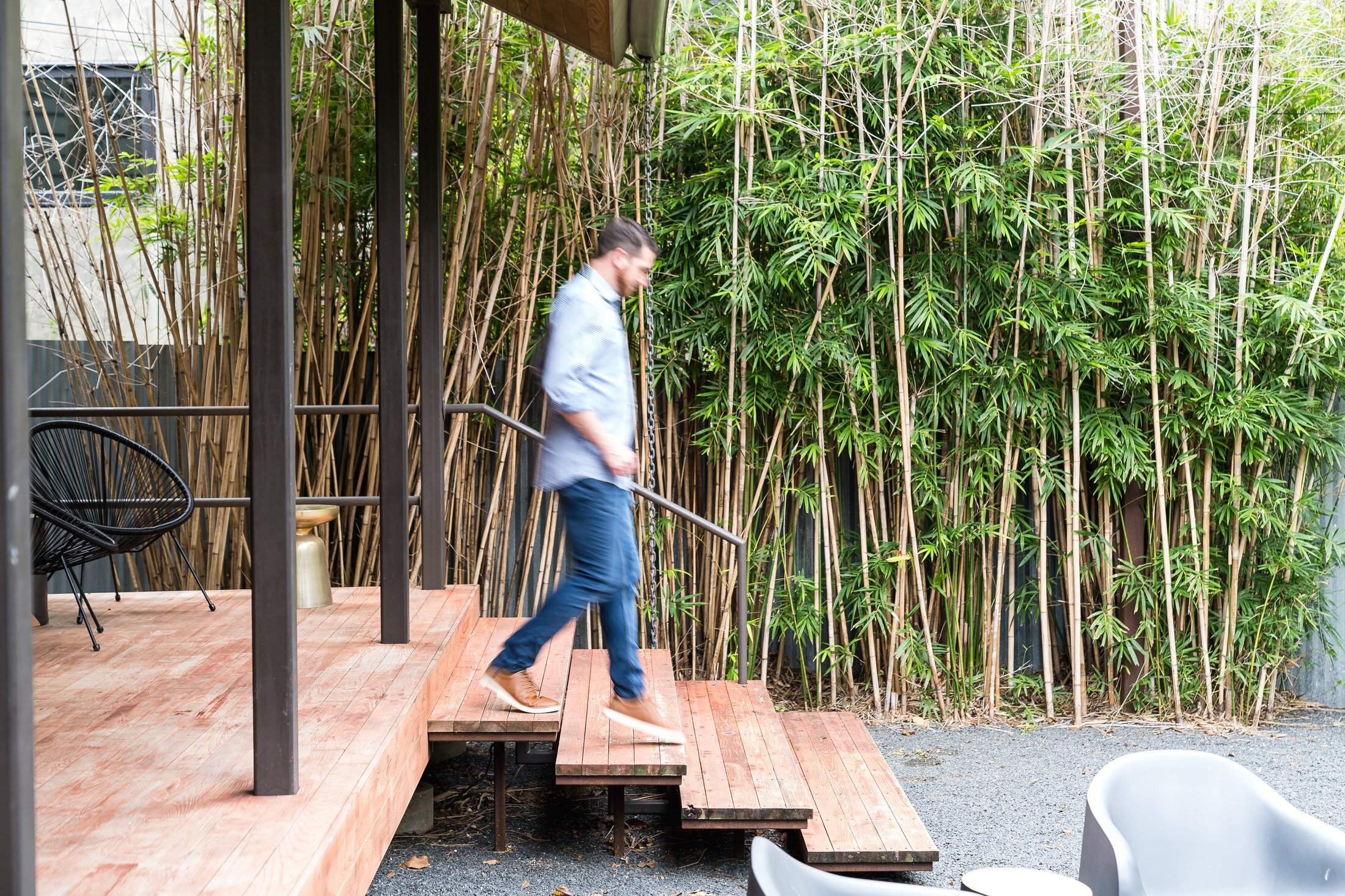 Vacasa employee walking across the patio of an Austin rental property