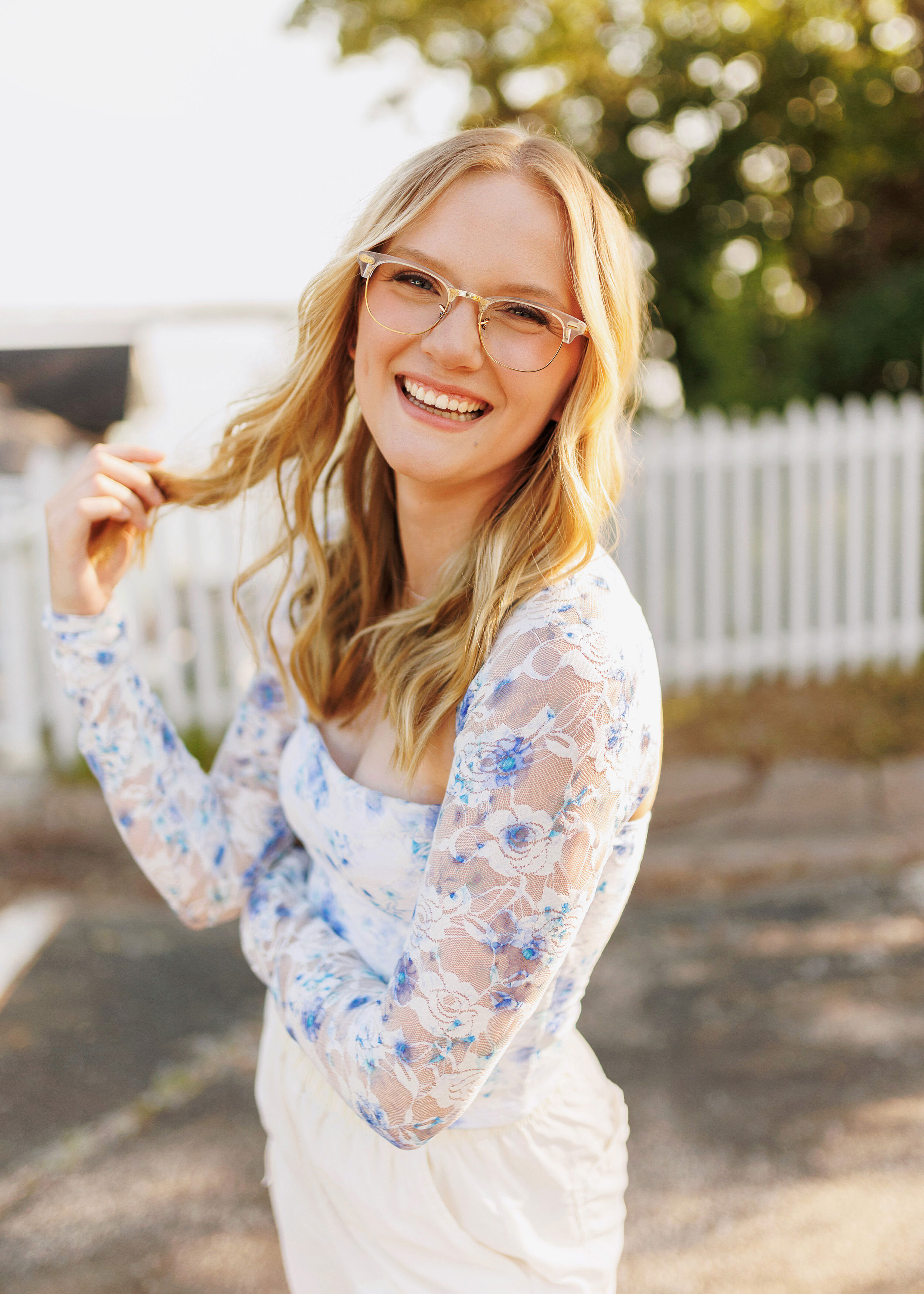 high school senior laughing and playing with her hair during her senior picture session in Buffalo MN