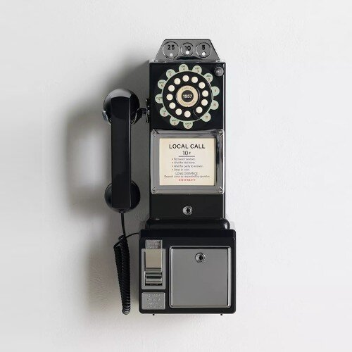 Black Crosley 1950s style payphone mounted on a white wall