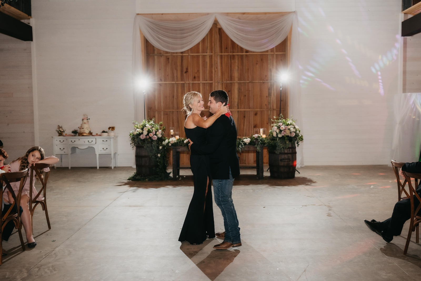 Mom and son sharing a dance in the White Barn