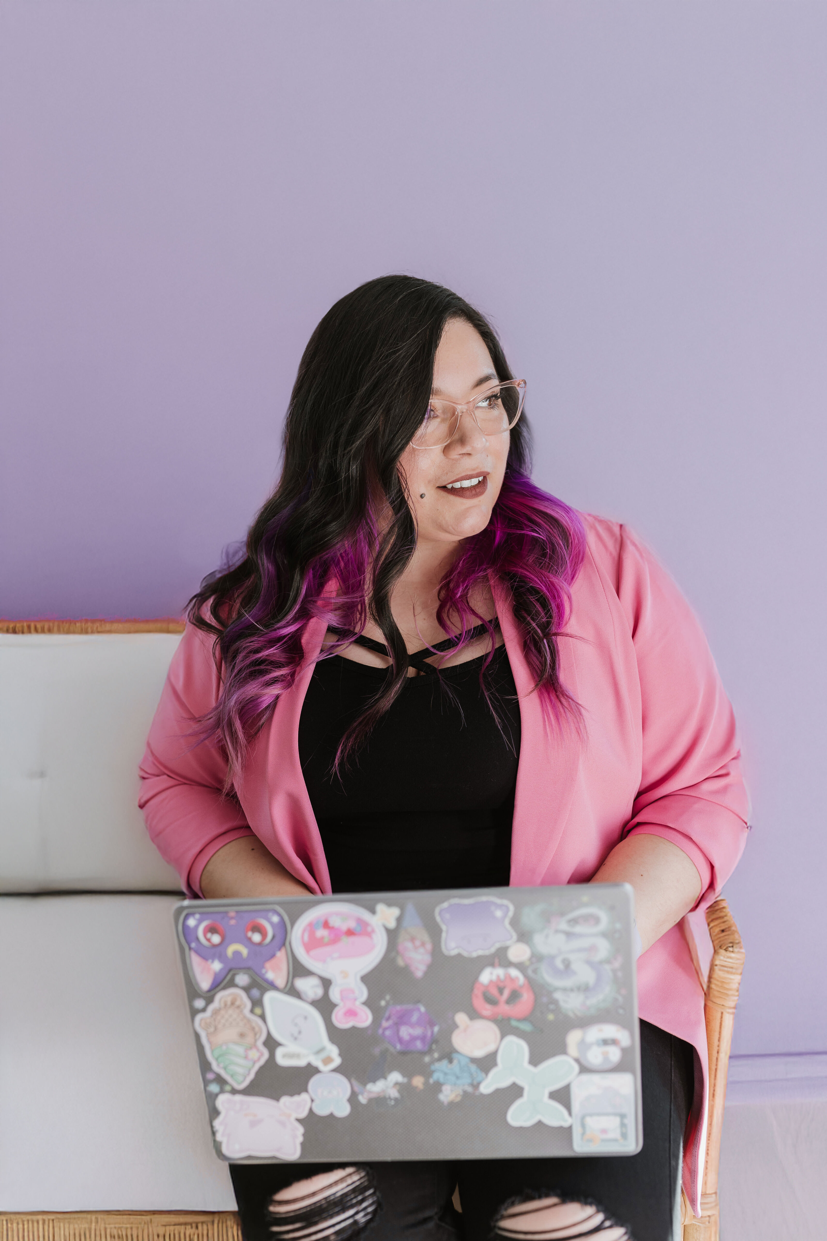 Ingrid, founder of Penguin Designing, working at her laptop