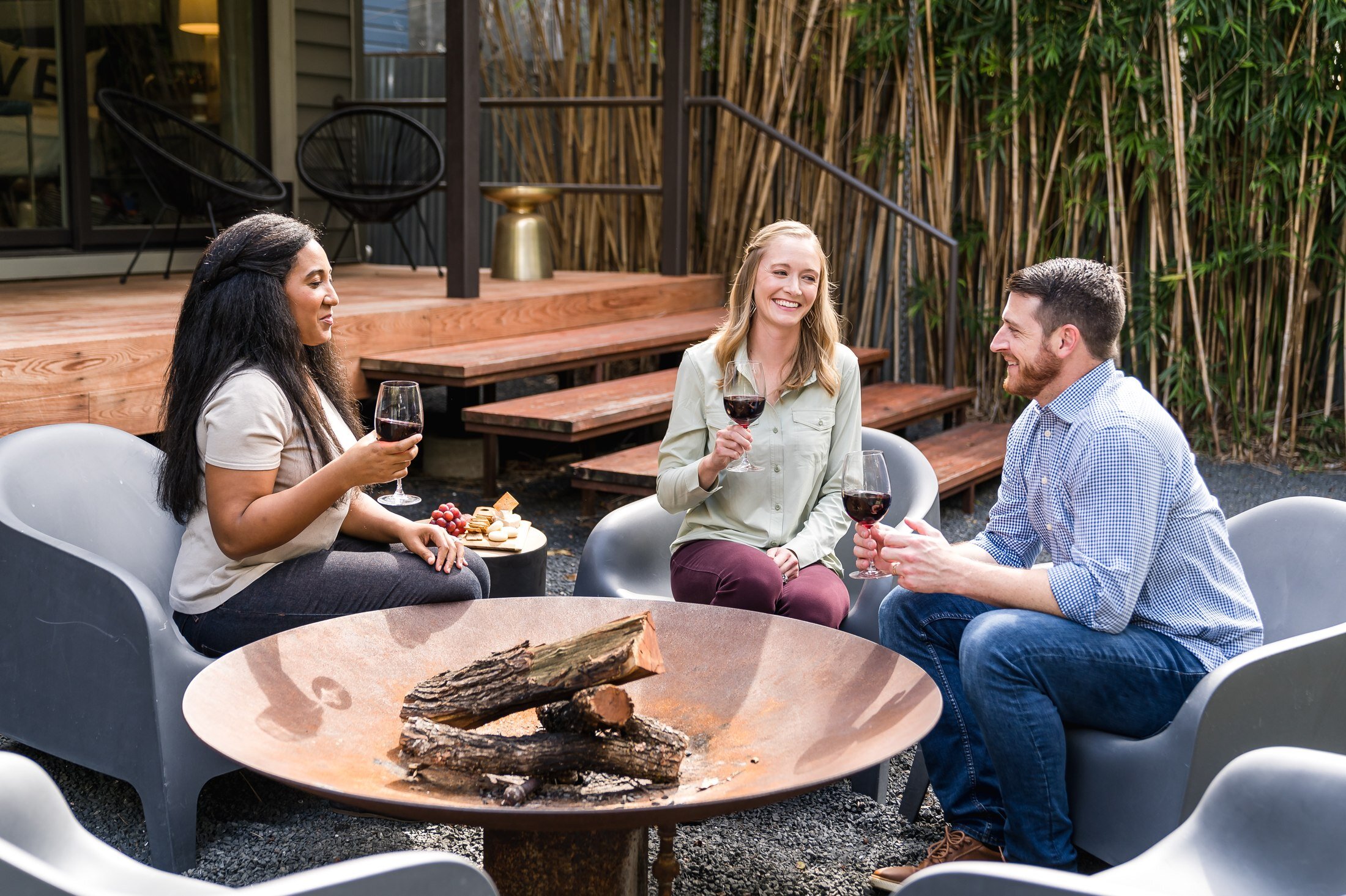 Guests relaxing by the firepit at a Vacasa vacation rental in Austin