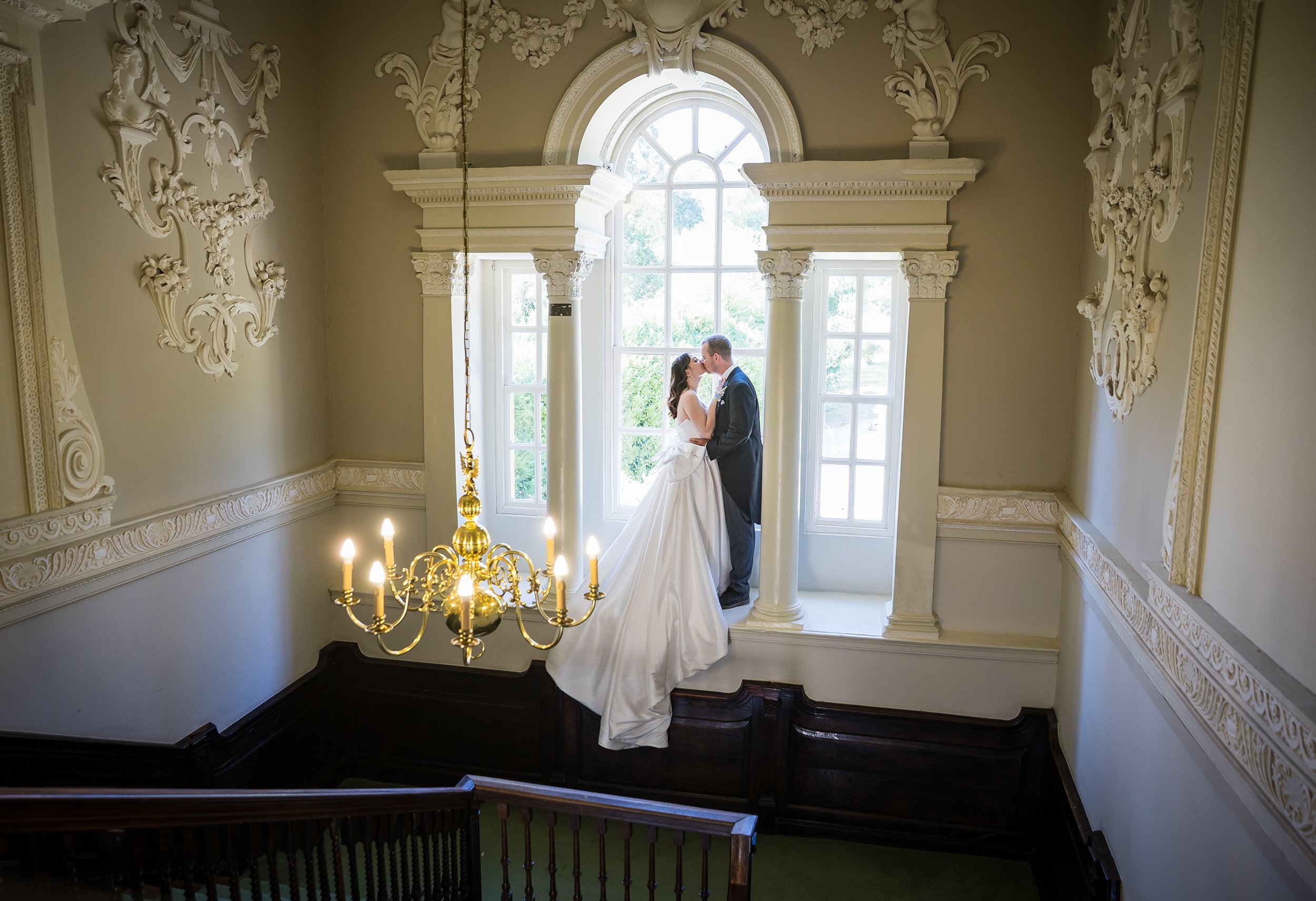 Bride and groom in sunlit chapel