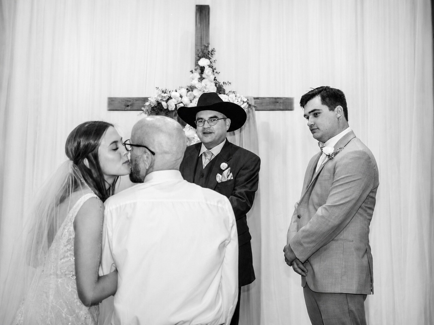 Black and white bride kissing her father before the ceremony