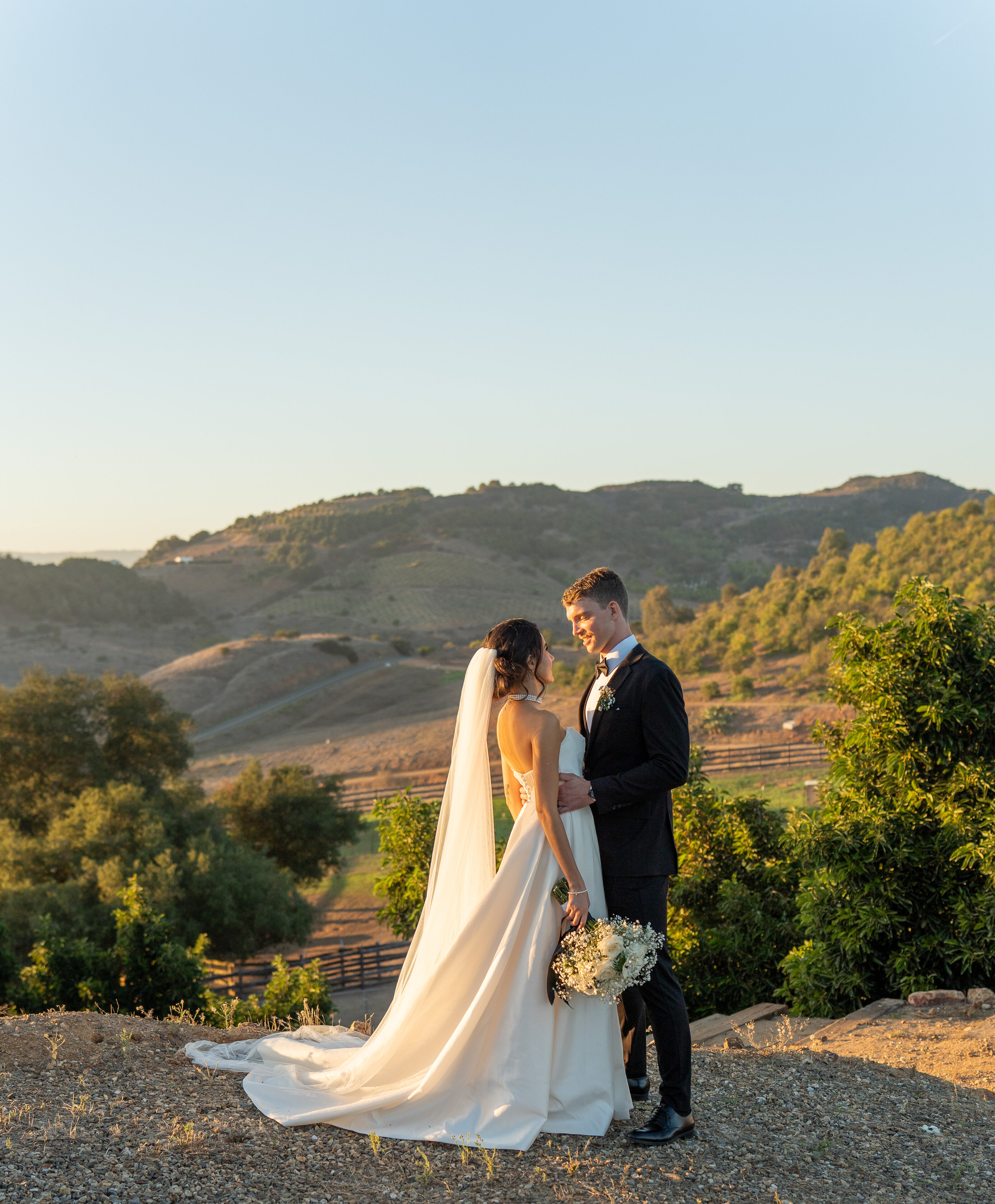 Couple on a hilltop at golden hour, wedding and elopement photographer. Temecula, California.