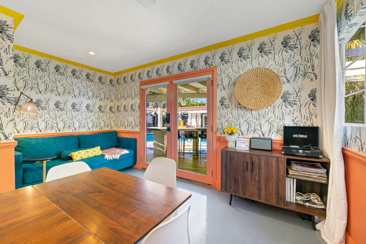 Styled lounge interior with palm print wallpaper